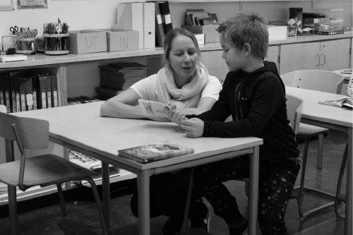 Boy-Reading-With-Teacher-500